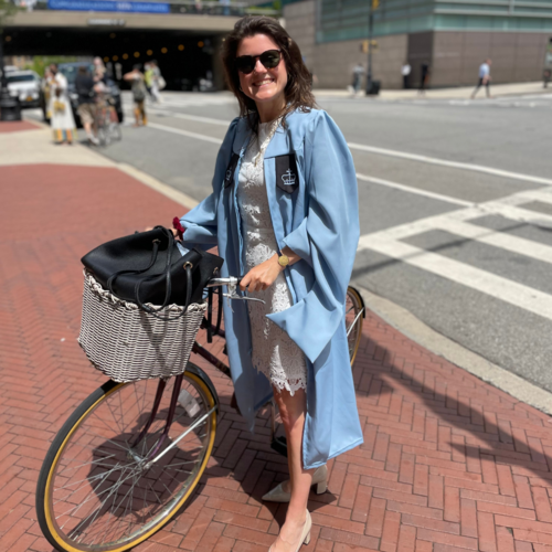 Photo of Sophie riding bike to graduation ceremony