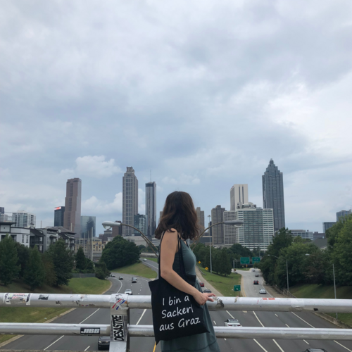 Photo of Sylvia standing on a bridge with a view