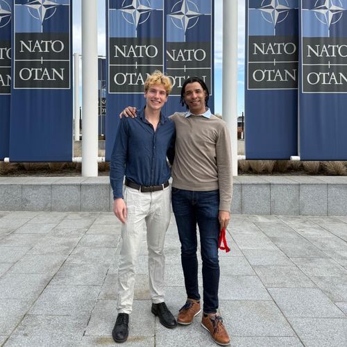 Lucas and Dune posing outside of NATO headquarters
