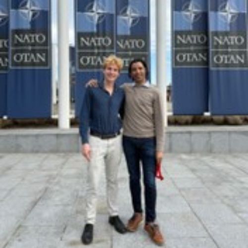 Lucas and Dune posing outside of NATO headquarters