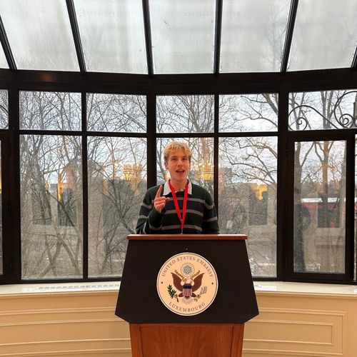 Lucas standing behind the lectern at the residence of the US ambassador to Luxembourg