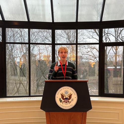 Lucas standing behind the lectern at the residence of the US ambassador to Luxembourg
