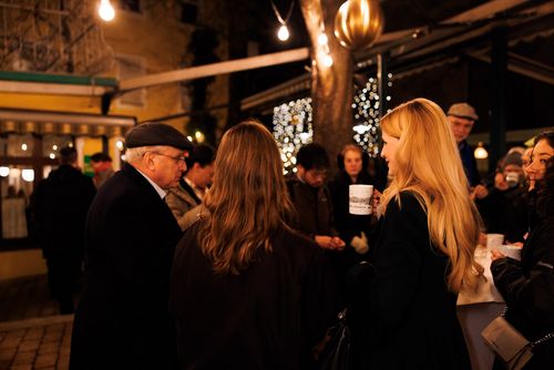 Photo of guests mingling at the garden reception before going inside for dinner