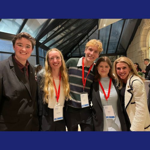 Lucas and other seminar attendees posing with Ambassador Stacey Feinberg