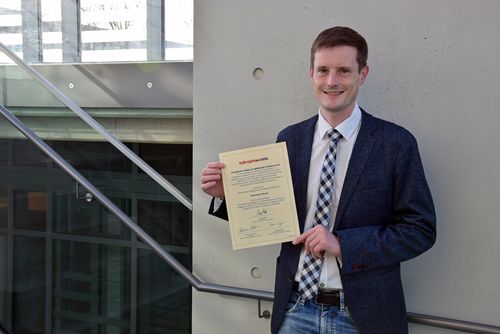 Photo of 2022 Fulbright Prize winner Christoph Straub holding certificate
