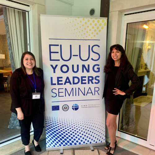 Photo of Diana Sosa and colleague standing in front of seminar rollup