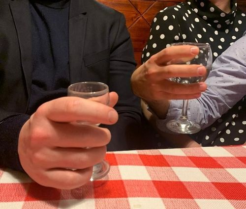 Photo of Wastl's bloated hand holding a shot glass