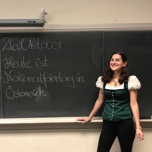 Photo of Sylvia Rainer standing at chalkboard